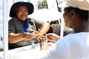 Ms Nokuzola Zaza demonstrating to the community members on how to wash hands hygienically